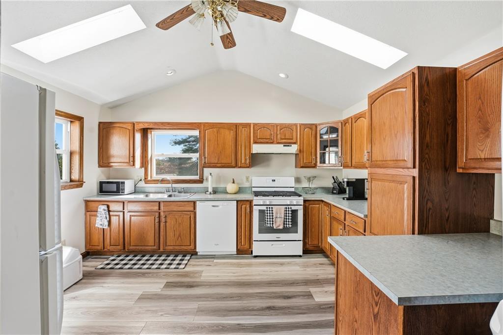 903 Ottawa Mercer, PA 16137 - Photo 22 of 42 a kitchen with stainless steel appliances granite countertop a stove top oven a refrigerator a sink and dishwasher with wooden floor