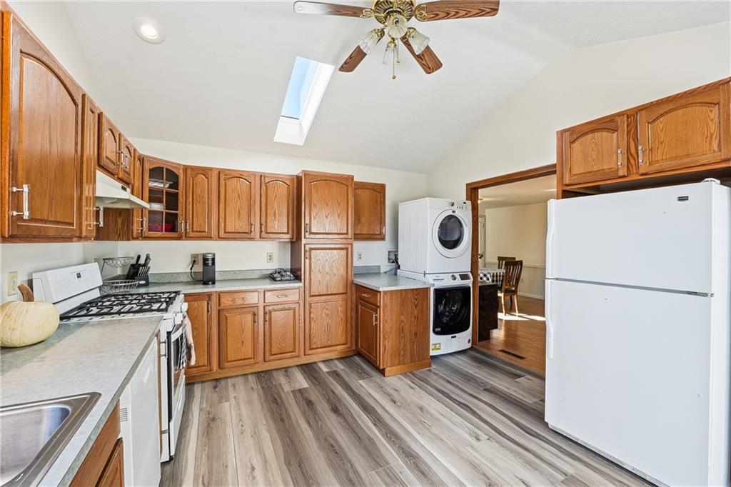 903 Ottawa Mercer, PA 16137 - Photo 26 of 42 a kitchen with a refrigerator a stove a sink dishwasher and wooden cabinets