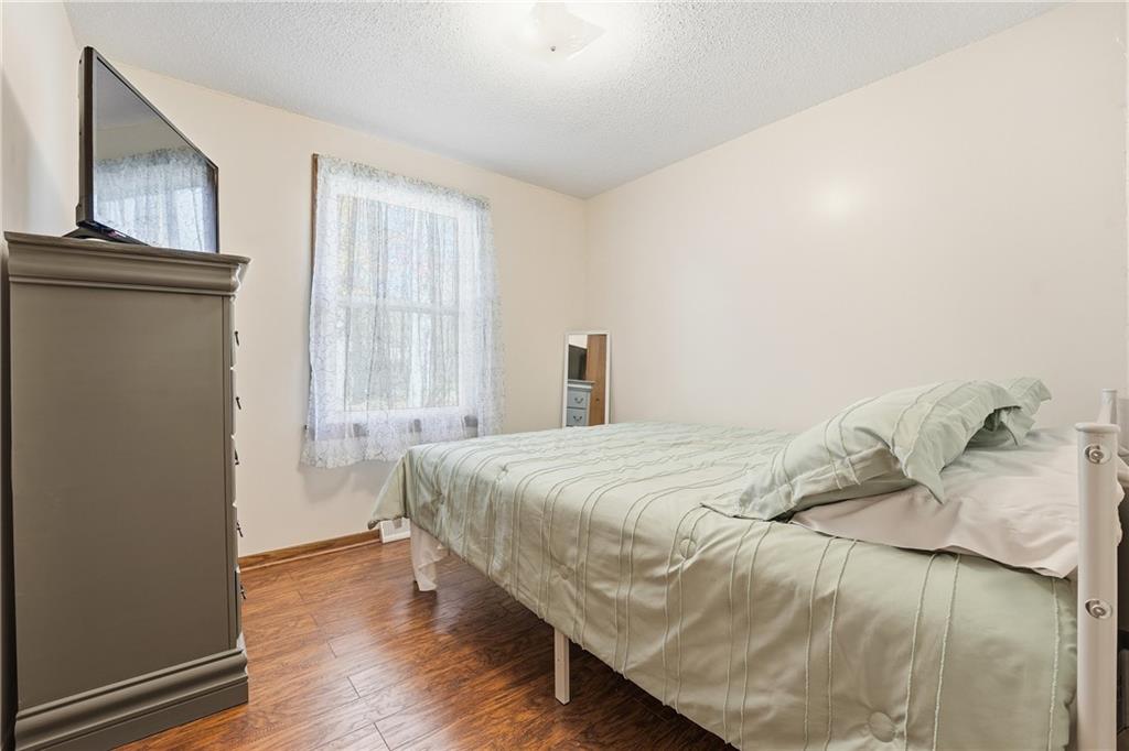 903 Ottawa Mercer, PA 16137 - Photo 29 of 42 a bedroom with a bed and wooden floor