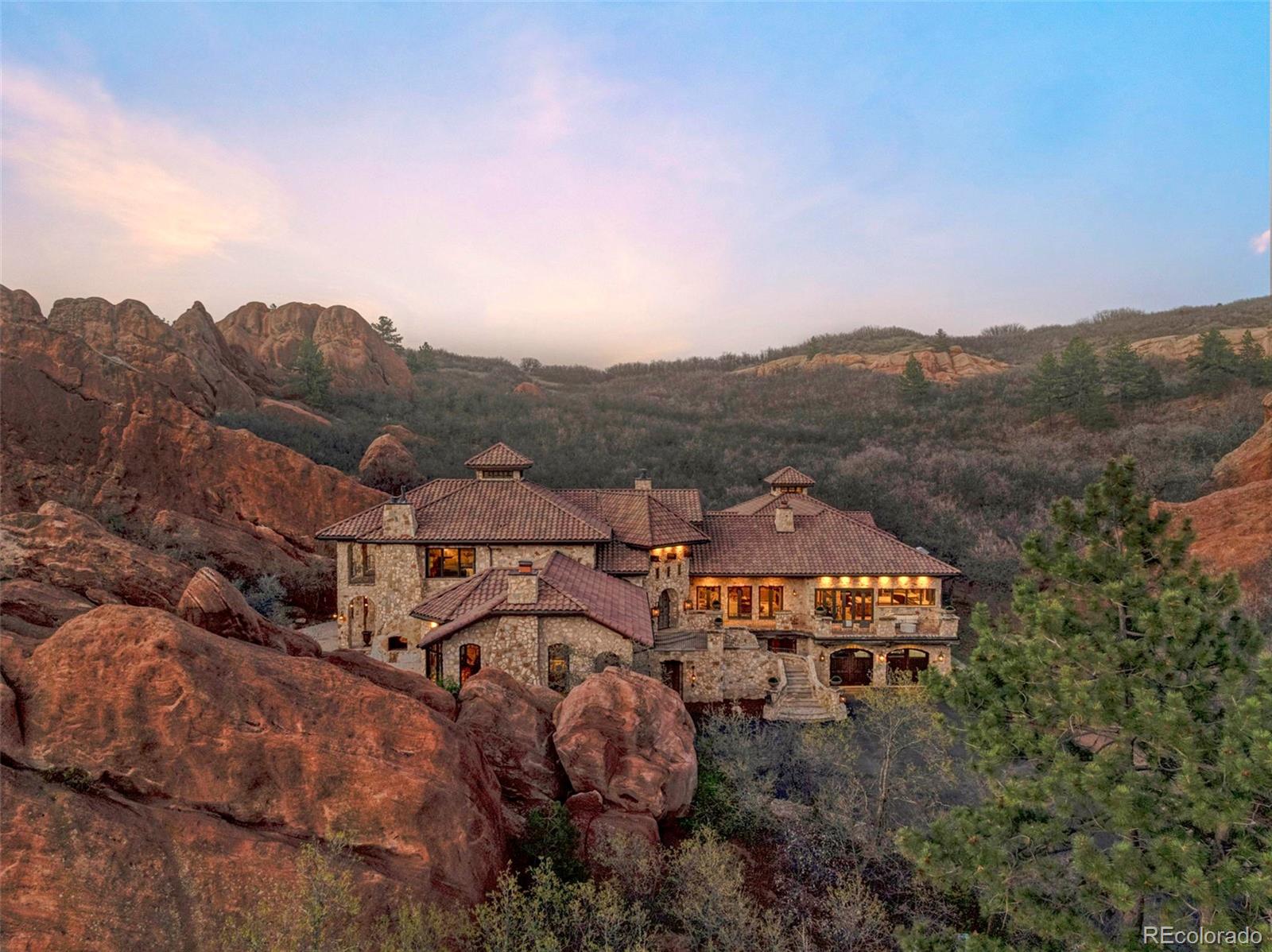 3755 North Rampart Range Road Littleton, CO 80125 - Photo 2 of 50 an aerial view of a house with a mountain view