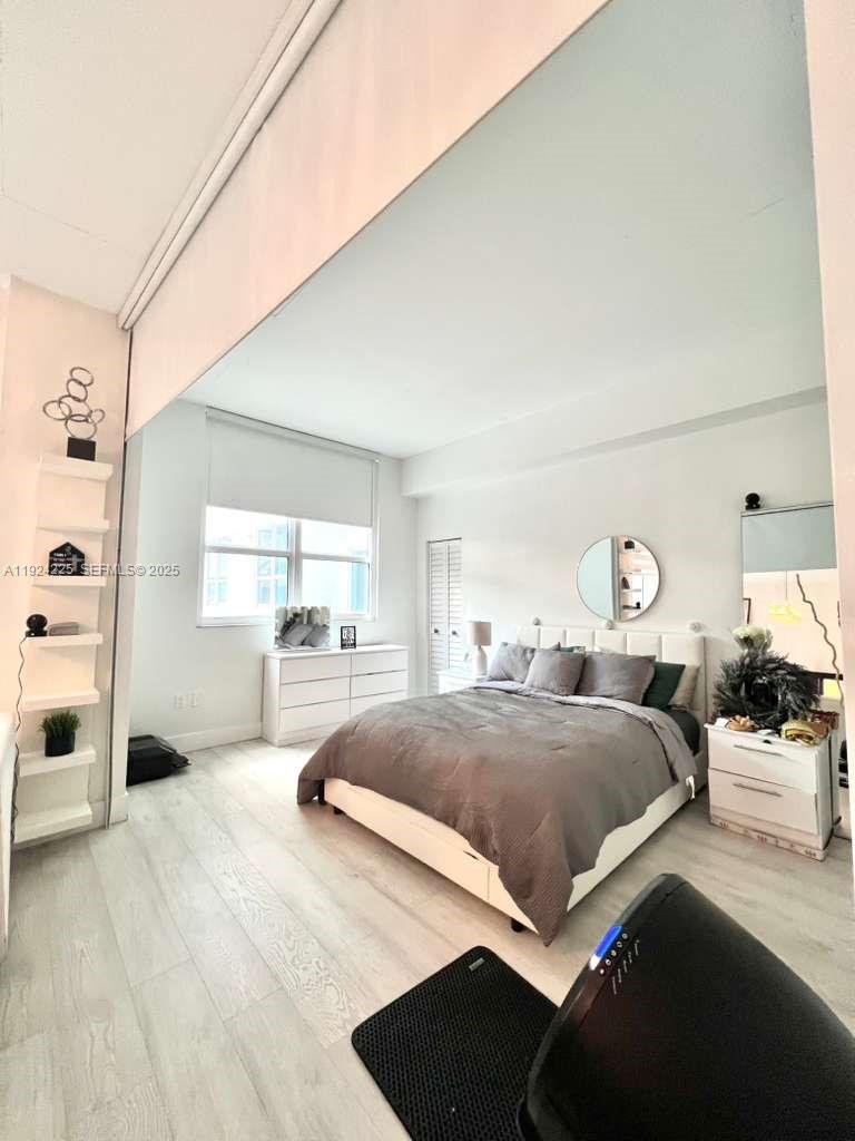 133 Northeast 2nd Avenue, Unit 208 Miami, FL 33132 - Photo 11 of 22 a bedroom with a bed and a large window