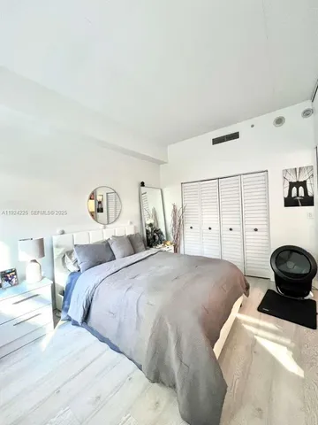 a bedroom with a bed and a cabinets