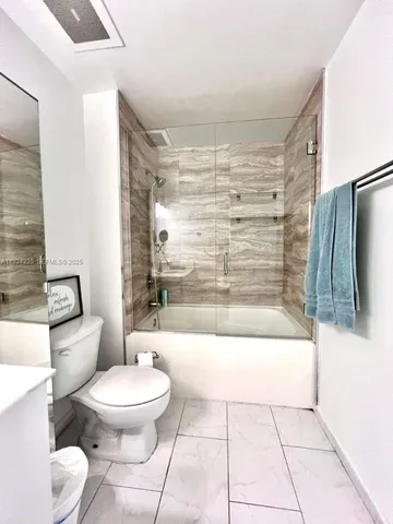 a bathroom with a toilet and a bath tub