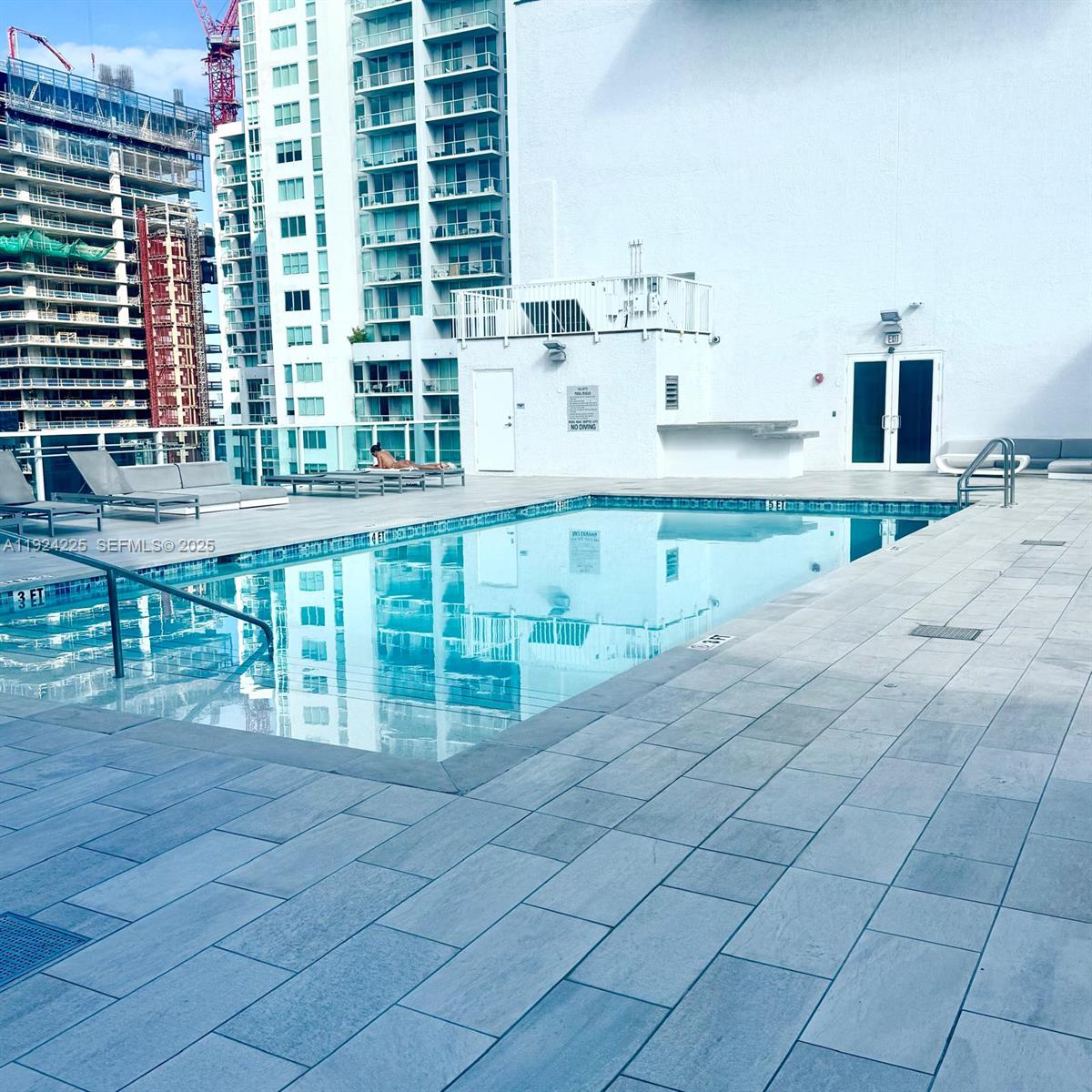133 Northeast 2nd Avenue, Unit 208 Miami, FL 33132 - Photo 15 of 22 a view of a kitchen with a sink and cabinets