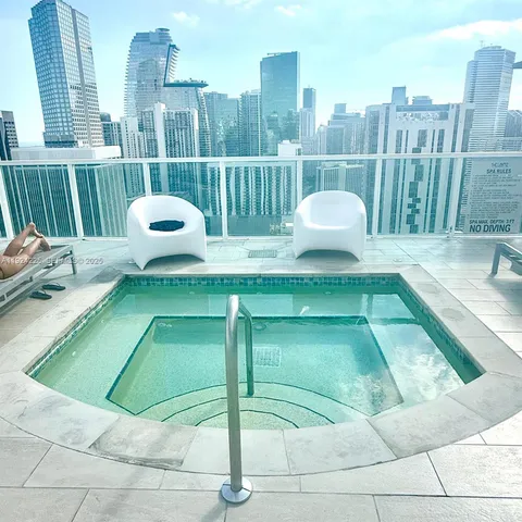a view of a balcony with a floor to ceiling window next to a yard