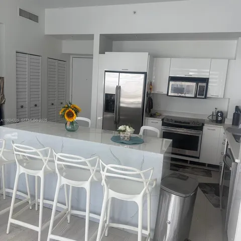 a kitchen with a sink cabinets and appliances