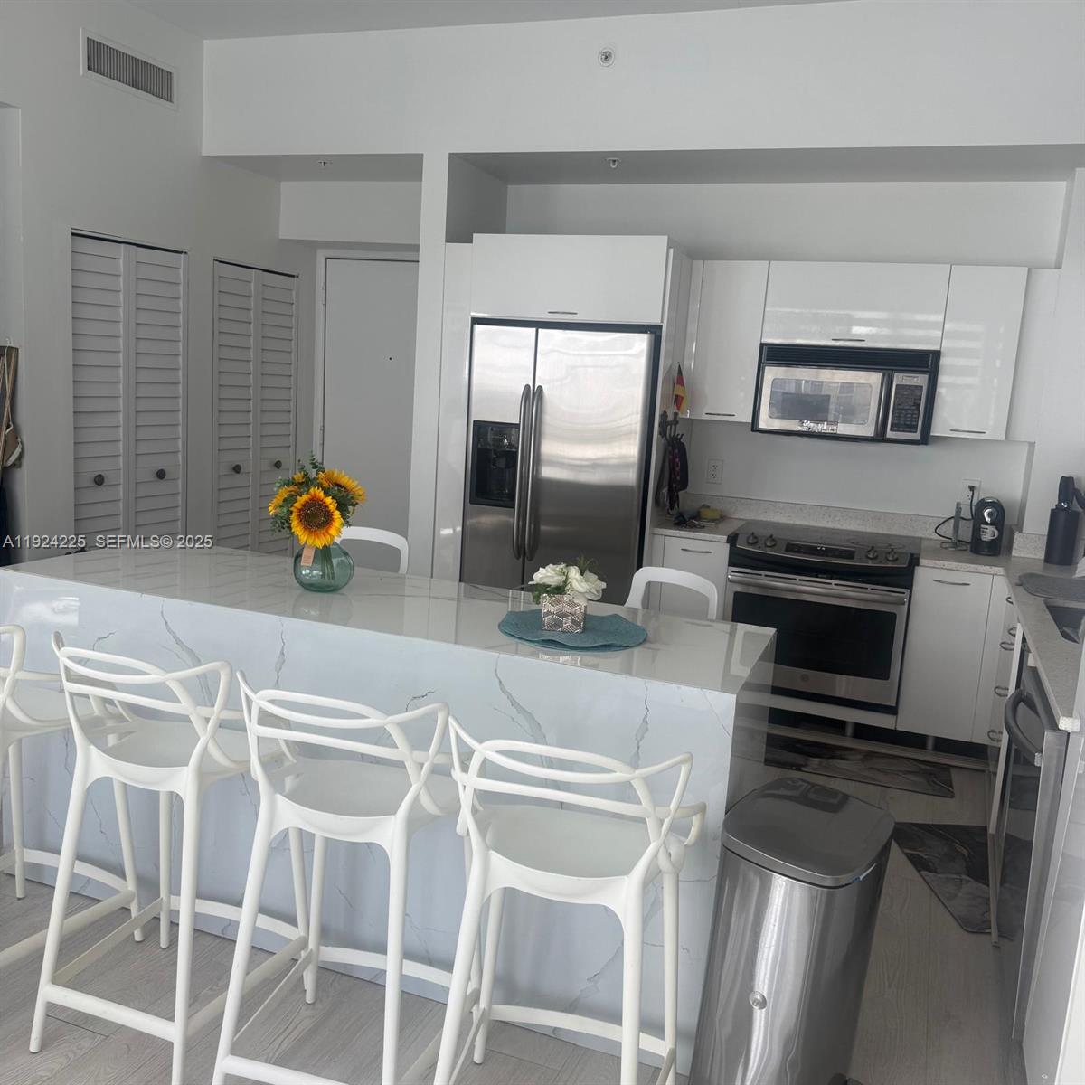 133 Northeast 2nd Avenue, Unit 208 Miami, FL 33132 - Photo 2 of 22 a kitchen with a sink cabinets and appliances