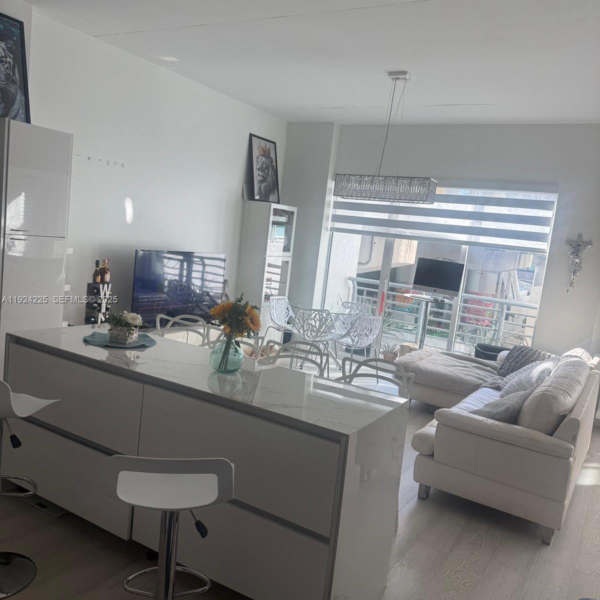 133 Northeast 2nd Avenue, Unit 208 Miami, FL 33132 - Photo 6 of 22 a kitchen with stainless steel appliances a sink and a refrigerator