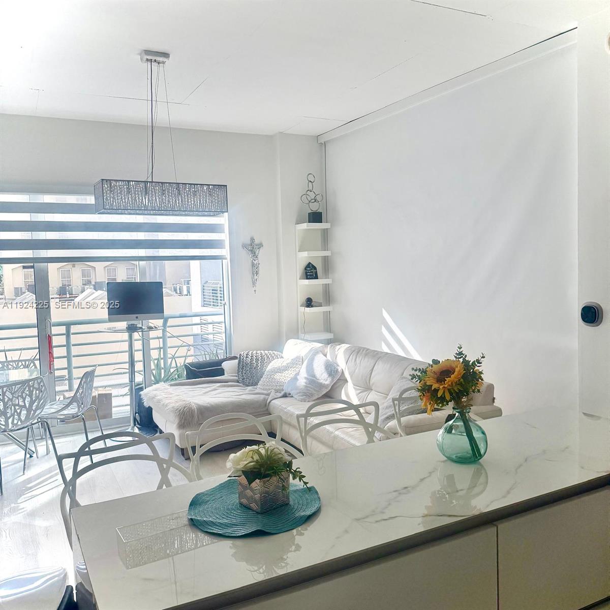 133 Northeast 2nd Avenue, Unit 208 Miami, FL 33132 - Photo 7 of 22 a kitchen with a table and chairs