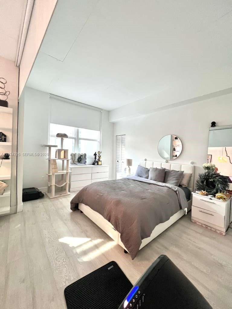 133 Northeast 2nd Avenue, Unit 208 Miami, FL 33132 - Photo 10 of 22 a bedroom with a bed and a view of kitchen