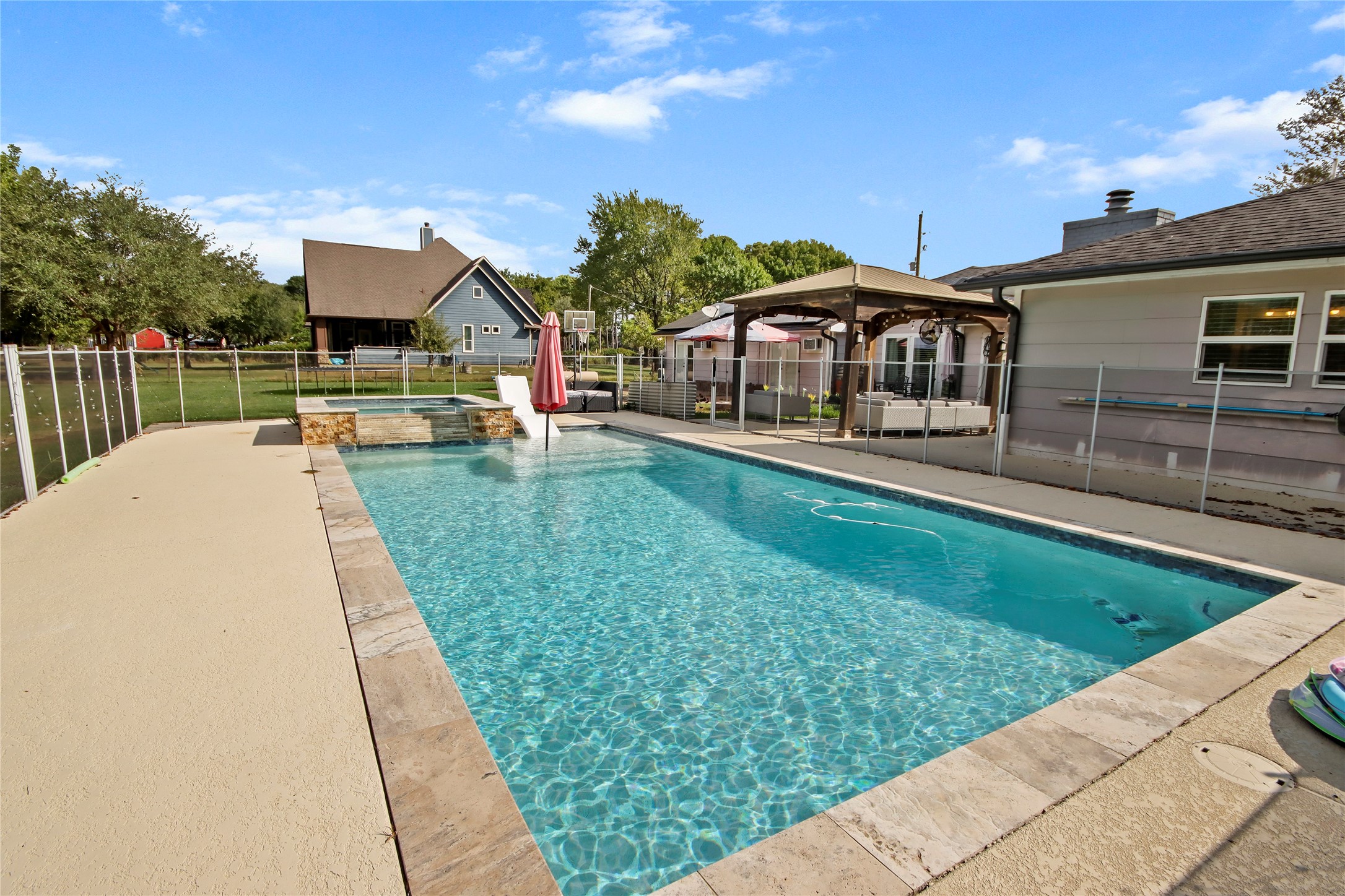 3527 Eula Morgan Road Katy, TX 77493 - Photo 16 of 23 The sparkling pool is the backyard's centerpiece, complete with a raised spa, water features, and plenty of deck space for lounging.