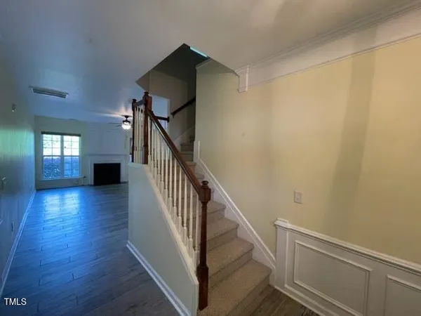 a view of entryway and hall with wooden floor