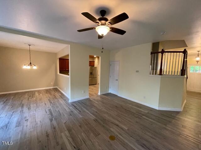 8203 Saltwood Place Raleigh, NC 27617 - Photo 6 of 24 a view of an empty room with window and wooden floor