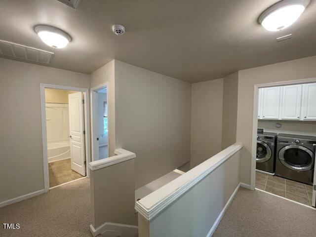 8203 Saltwood Place Raleigh, NC 27617 - Photo 9 of 24 a view of a hallway to a room with washer and dryer