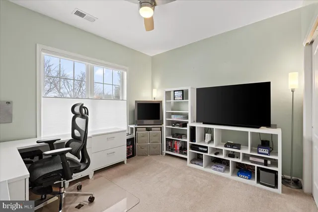 a bedroom with a bed and glass windows