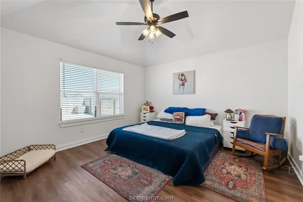 a bedroom with a bed a table and chair