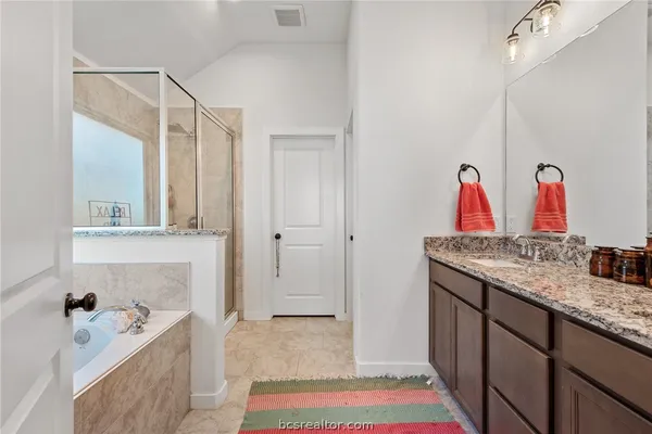 a bathroom with a sink vanity and a mirror