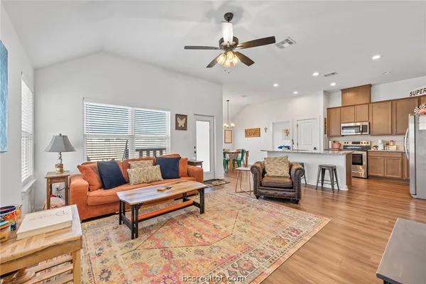 a living room with furniture and kitchen view