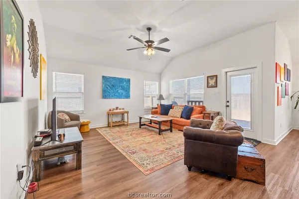 a living room with furniture and wooden floor