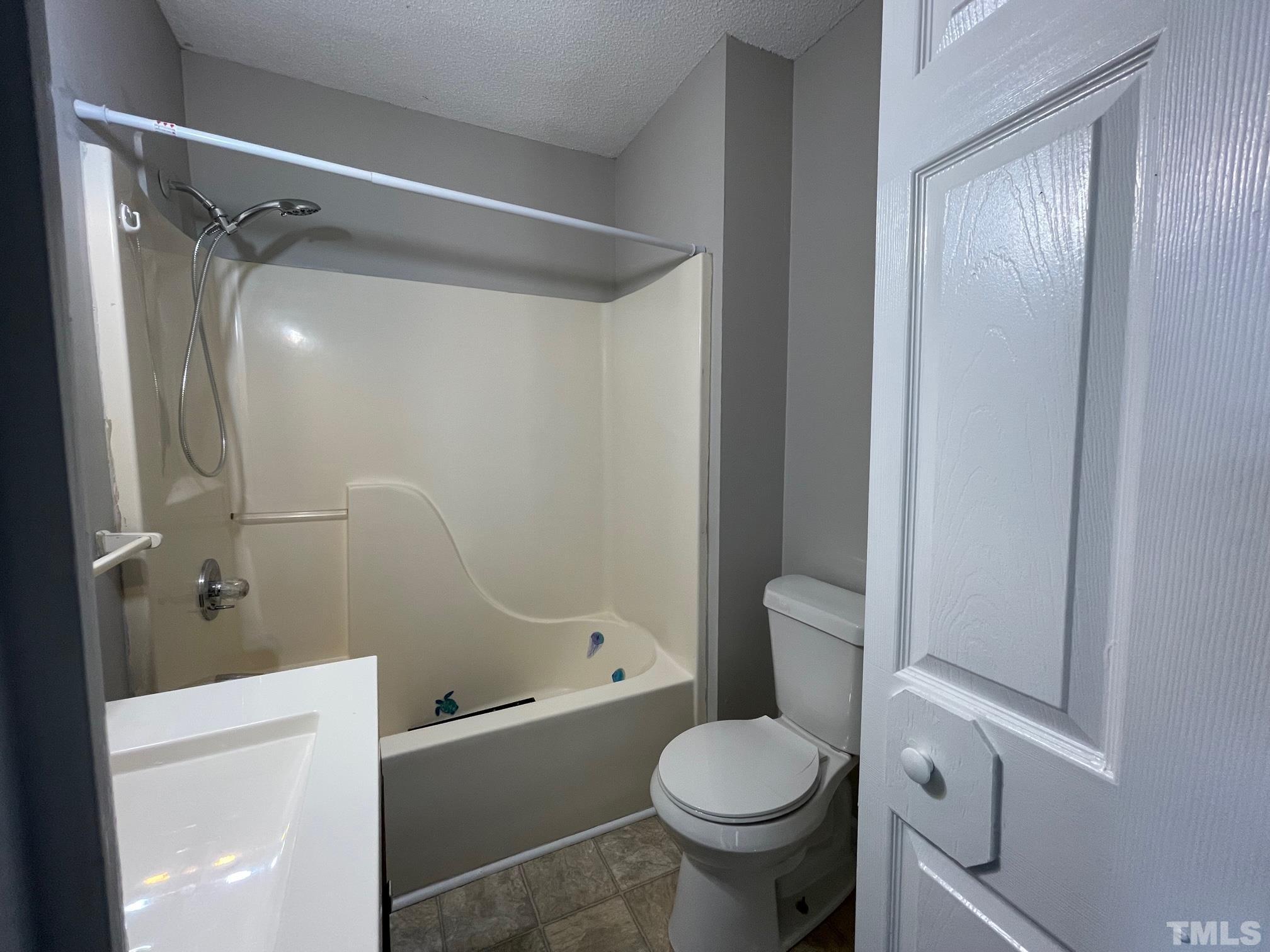 231 Smith Drive Angier, NC 27501 - Photo 15 of 19 a bathroom with a toilet and a shower