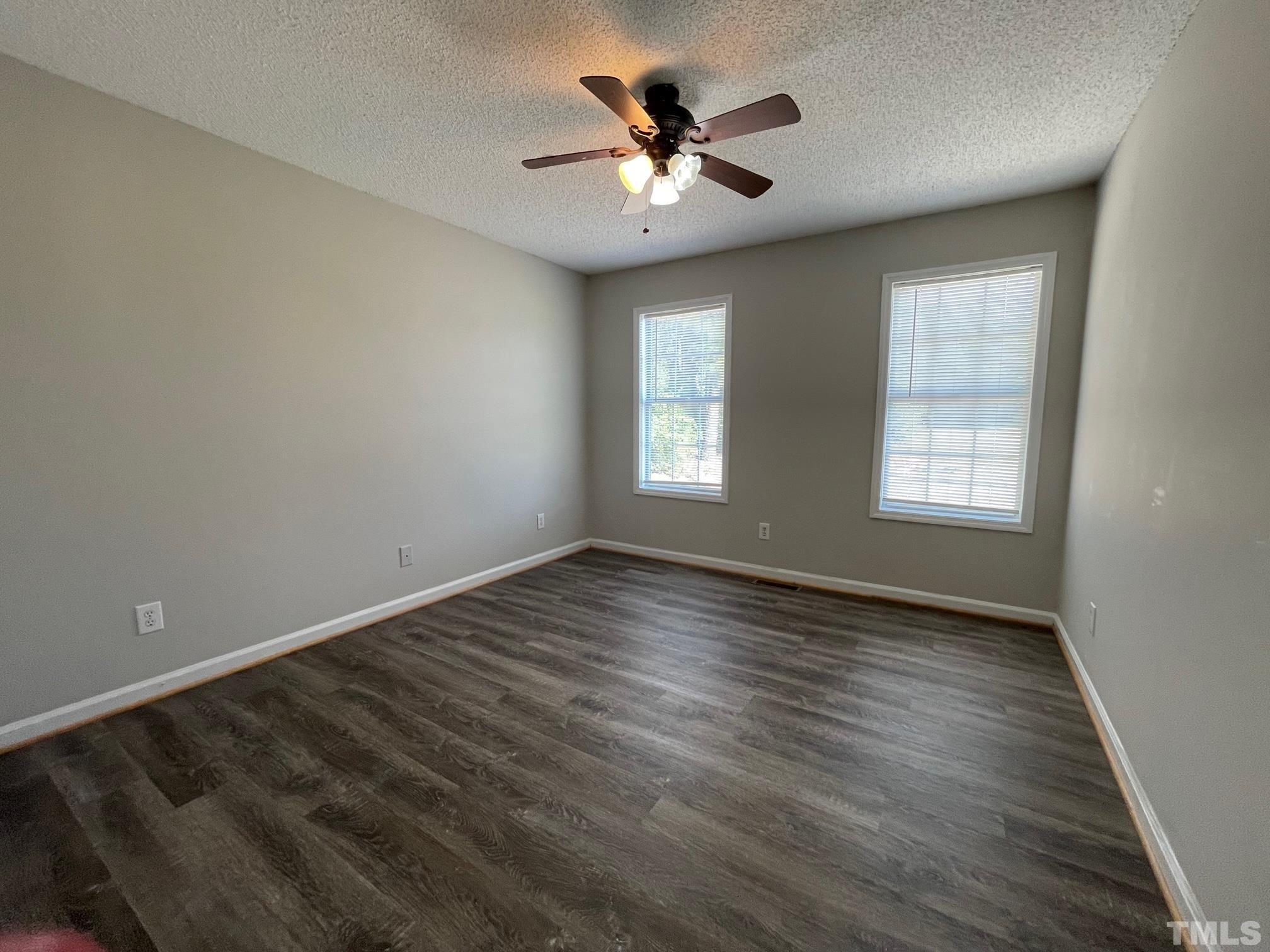 231 Smith Drive Angier, NC 27501 - Photo 16 of 19 a view of an empty room with window and wooden floor