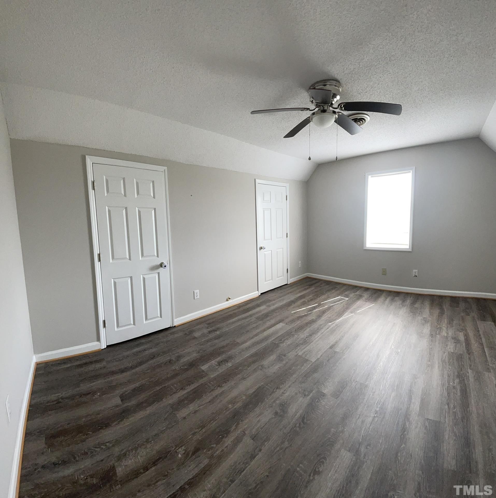 231 Smith Drive Angier, NC 27501 - Photo 17 of 19 an empty room with wooden floor fan and windows