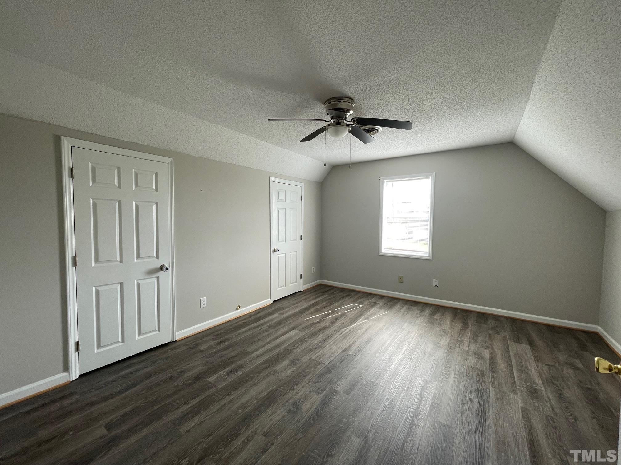 231 Smith Drive Angier, NC 27501 - Photo 18 of 19 a view of an empty room with a window and wooden floor