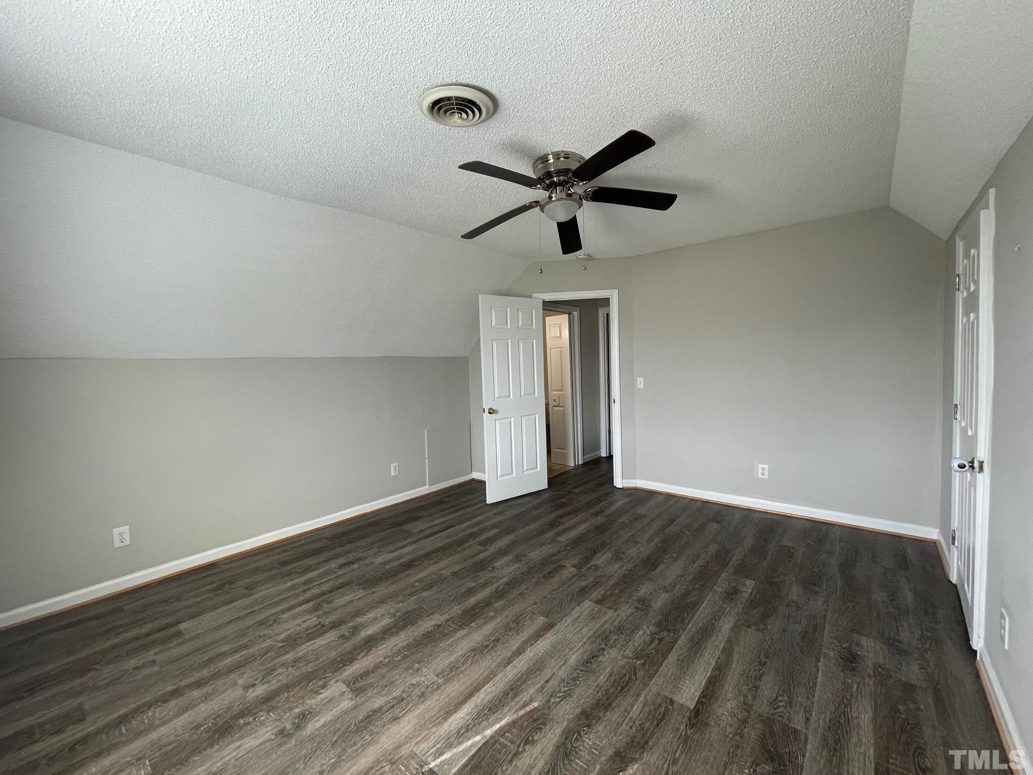 231 Smith Drive Angier, NC 27501 - Photo 19 of 19 a view of empty room with wooden floor and fan