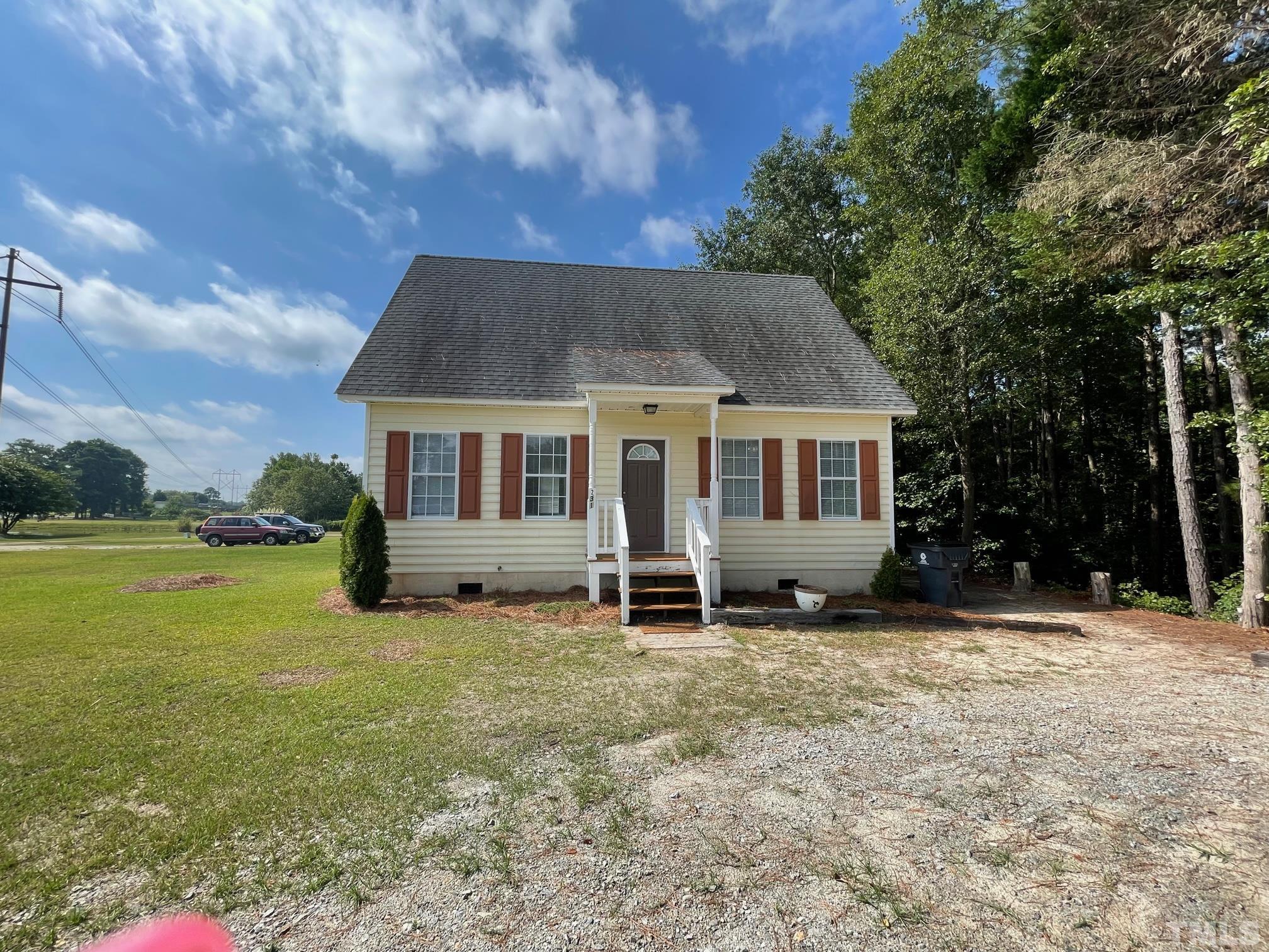 231 Smith Drive Angier, NC 27501 - Photo 2 of 19 a house that has a tree in front of it
