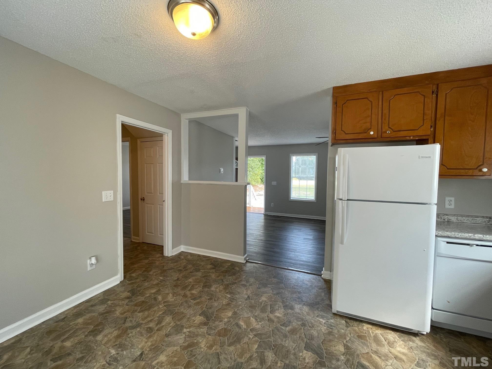 231 Smith Drive Angier, NC 27501 - Photo 8 of 19 a view of a kitchen with a refrigerator a microwave and a sink