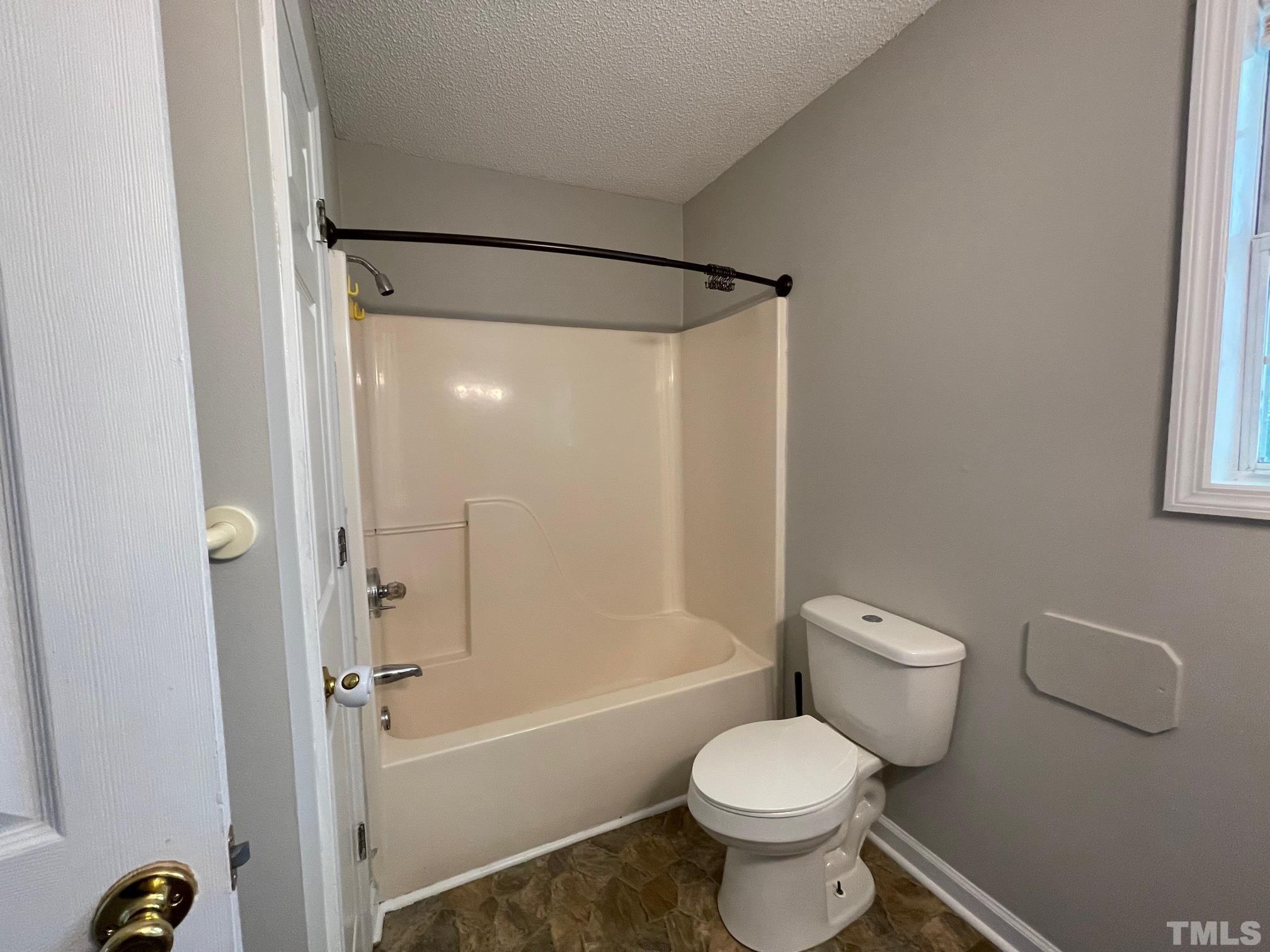 231 Smith Drive Angier, NC 27501 - Photo 10 of 19 a bathroom with a toilet and a shower