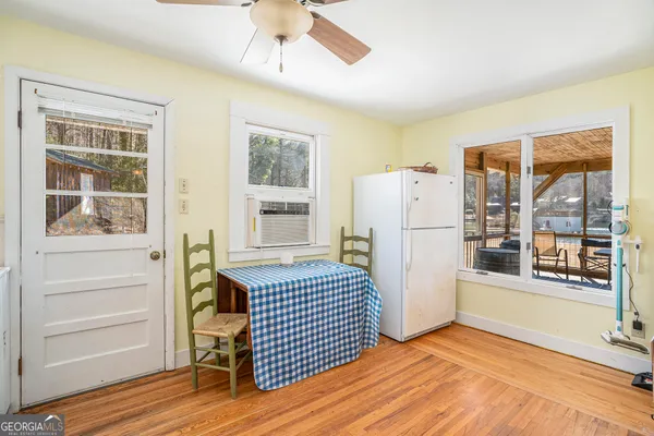 a view of kitchen with furniture and refrigerator