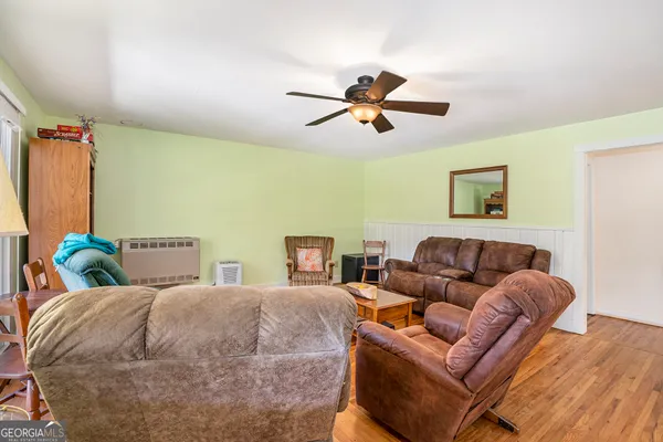 a bed room with a bed a couch and a window