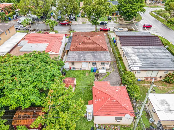 an aerial view of a house with a yard and potted plants