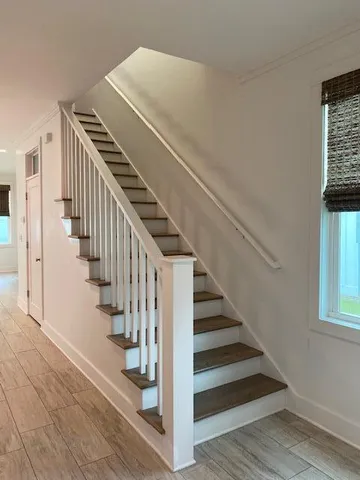a view of an entryway with wooden floor