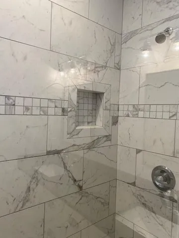 a bathroom with a double vanity sink and a mirror