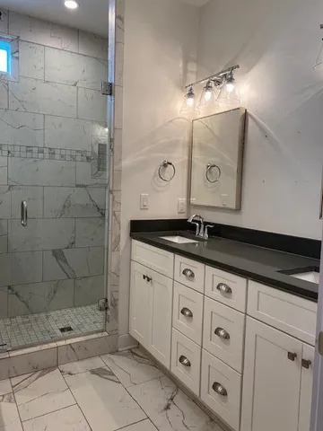 a bathroom with a bathtub and shower
