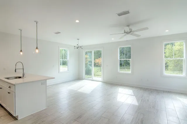 a kitchen with a sink stainless steel appliances and white cabinets
