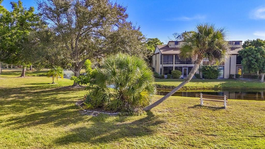 3 Quails Run Boulevard, Unit 8 Englewood, FL 34223 - Photo 22 of 37 a view of a swimming pool with a house in the background