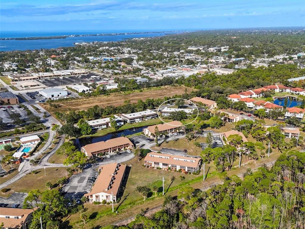 3 Quails Run Boulevard, Unit 8 Englewood, FL 34223 - Photo 37 of 37 an aerial view of residential building with parking and yard