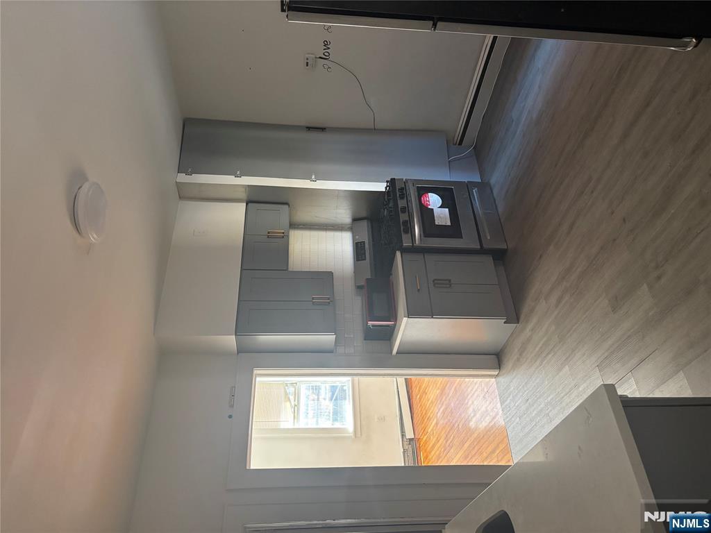 86 Center Street, Unit 2F Clifton, NJ 07011 - Photo 11 of 11 a kitchen with a refrigerator and a sink