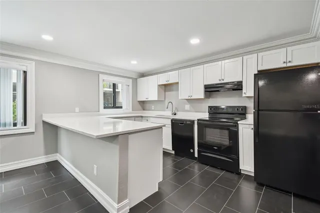 a kitchen with a stove microwave and sink