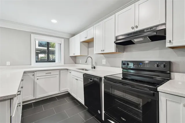 a kitchen with stainless steel appliances a refrigerator sink and cabinets