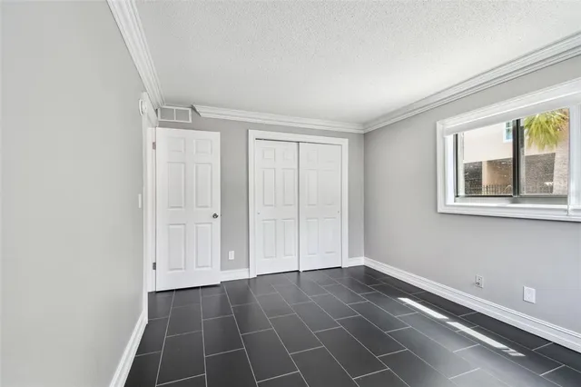 a view of a hallway with wooden floor and entryway