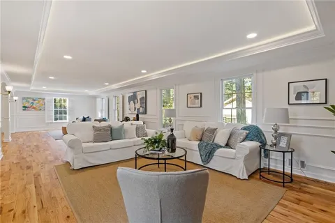 a large kitchen with stainless steel appliances granite countertop a stove a sink dishwasher and a microwave oven with white cabinets