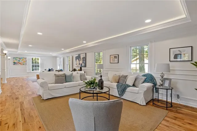 a large kitchen with stainless steel appliances granite countertop a stove a sink dishwasher and a microwave oven with white cabinets