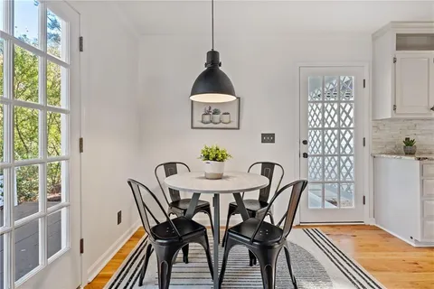 a kitchen with stainless steel appliances granite countertop white cabinets and a stove