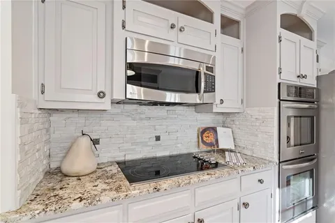 a bathroom with a sink vanity mirror and toilet
