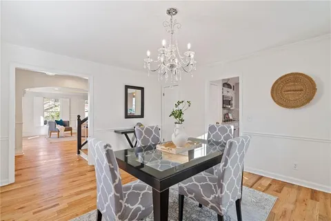 a view of empty room with wooden floor and window
