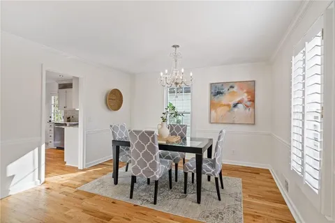 a view of a big room with wooden floor and a ceiling fan
